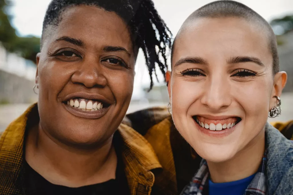 Multicultural female friends smiling at the camera